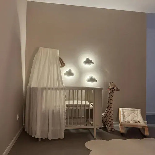 Three boucle cloud wall lamps in customer nursery – cloud night lights above baby crib with canopy