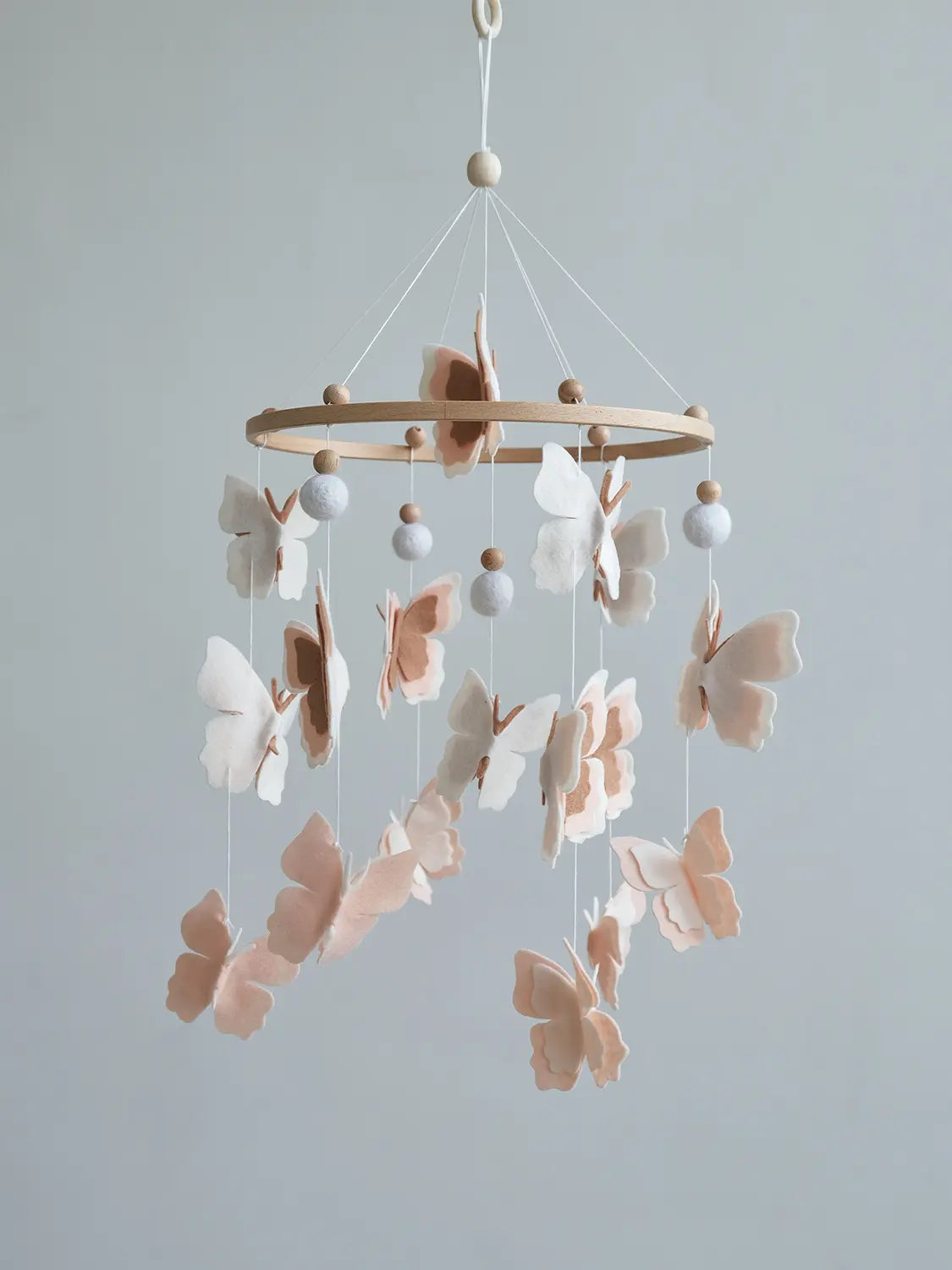 Handmade felt baby mobile with blush butterflies and white wool balls – neutral nursery crib mobile