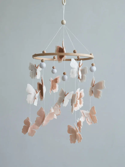 Handmade felt baby mobile with blush butterflies and white wool balls – neutral nursery crib mobile