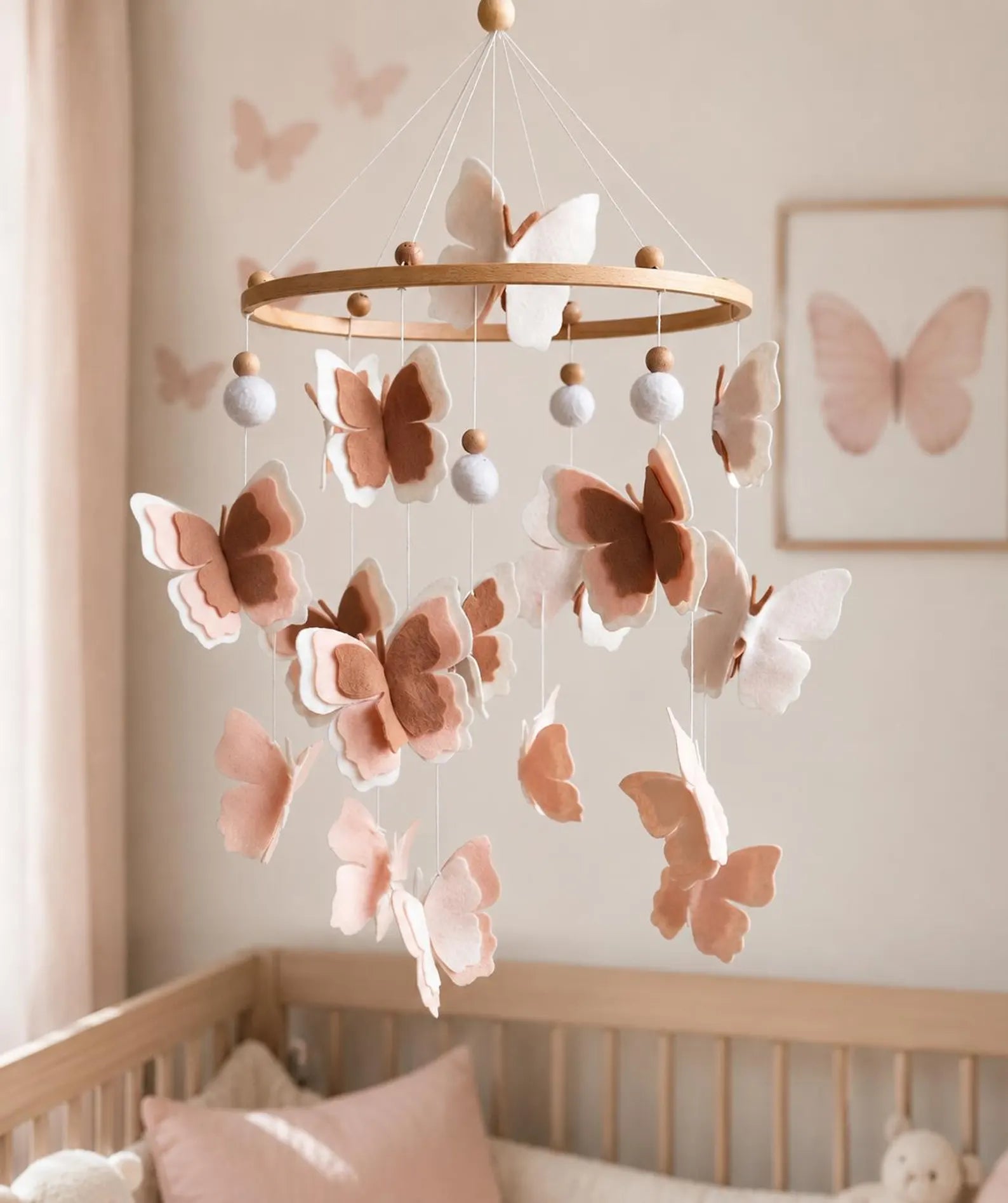 Felt blush butterfly mobile above crib in nursery – neutral baby girl room decor