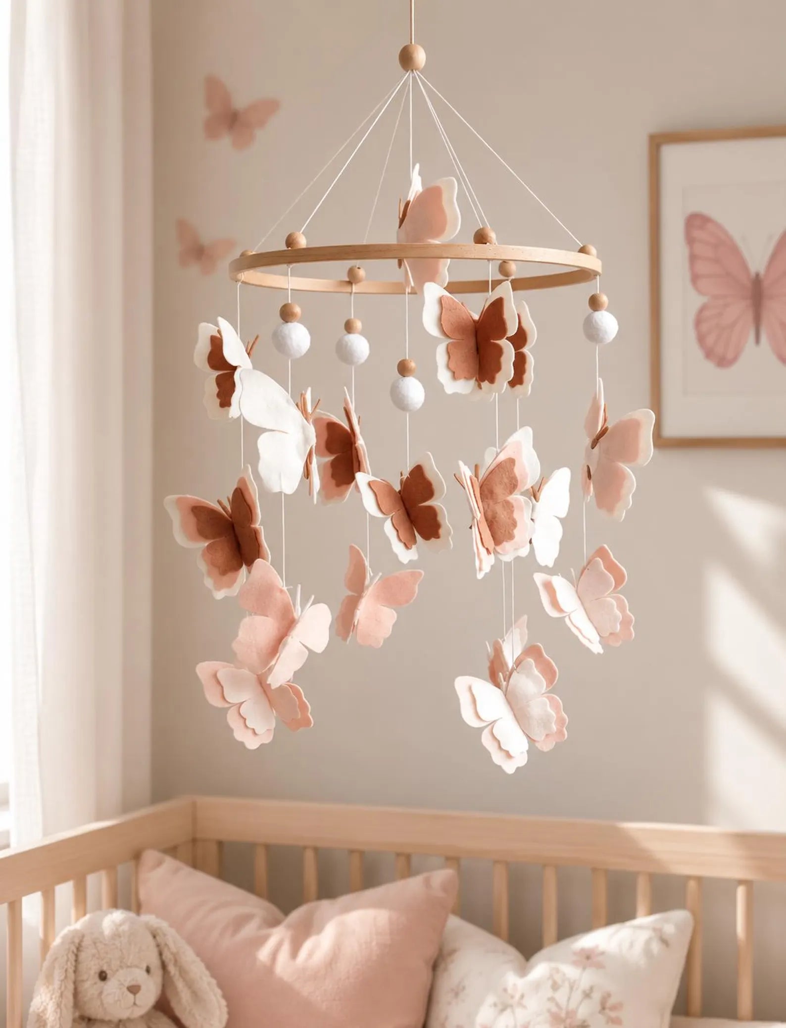 Felt blush butterfly mobile in sunny nursery with butterfly wall art – baby girl crib decor