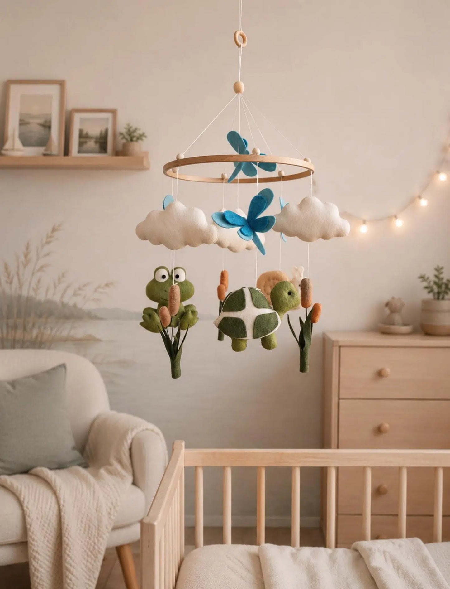 Felt baby mobile with frog and turtle hanging above crib – pond nursery decor