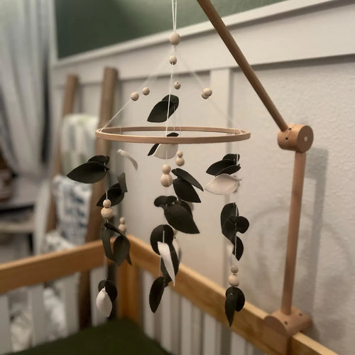 Green felt leaves mobile close-up – handmade eucalyptus crib mobile with wooden beads detail