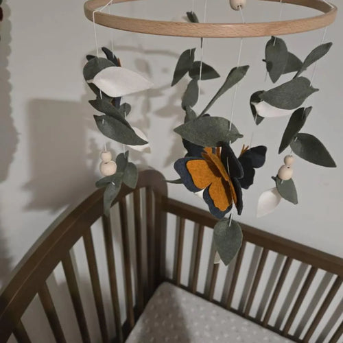 Monarch butterfly felt mobile over dark wood crib – handmade navy orange butterfly nursery mobile