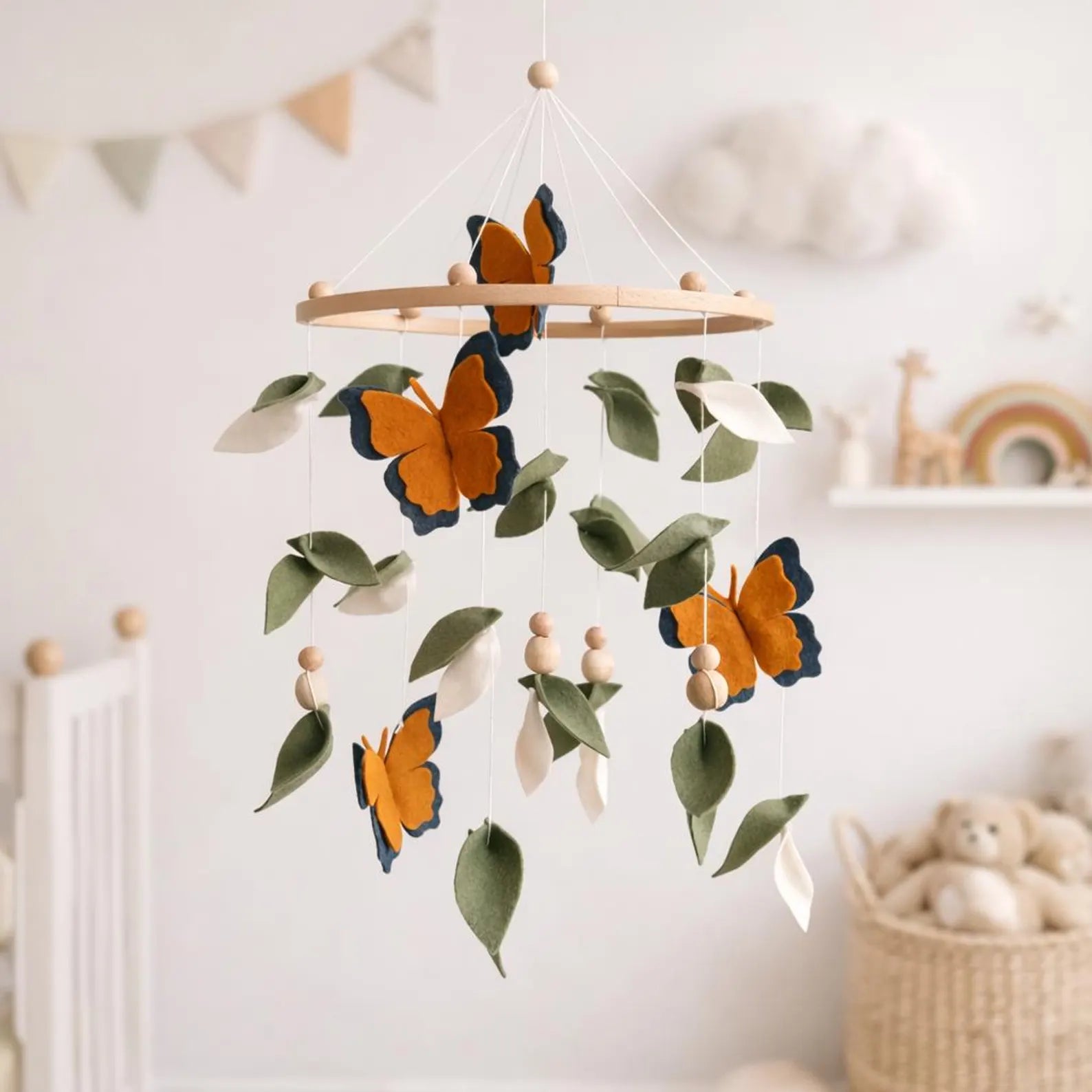 Felt monarch butterfly mobile in nursery with bunting and toys – nature baby room decor