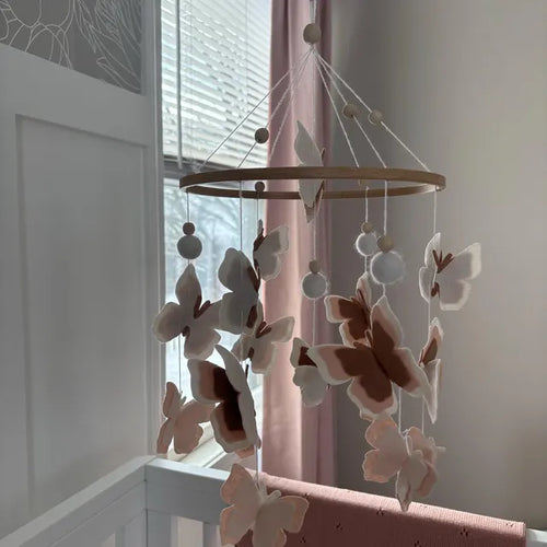 Customer holding felt mountain moon mobile – handmade woodland baby mobile with clouds and trees