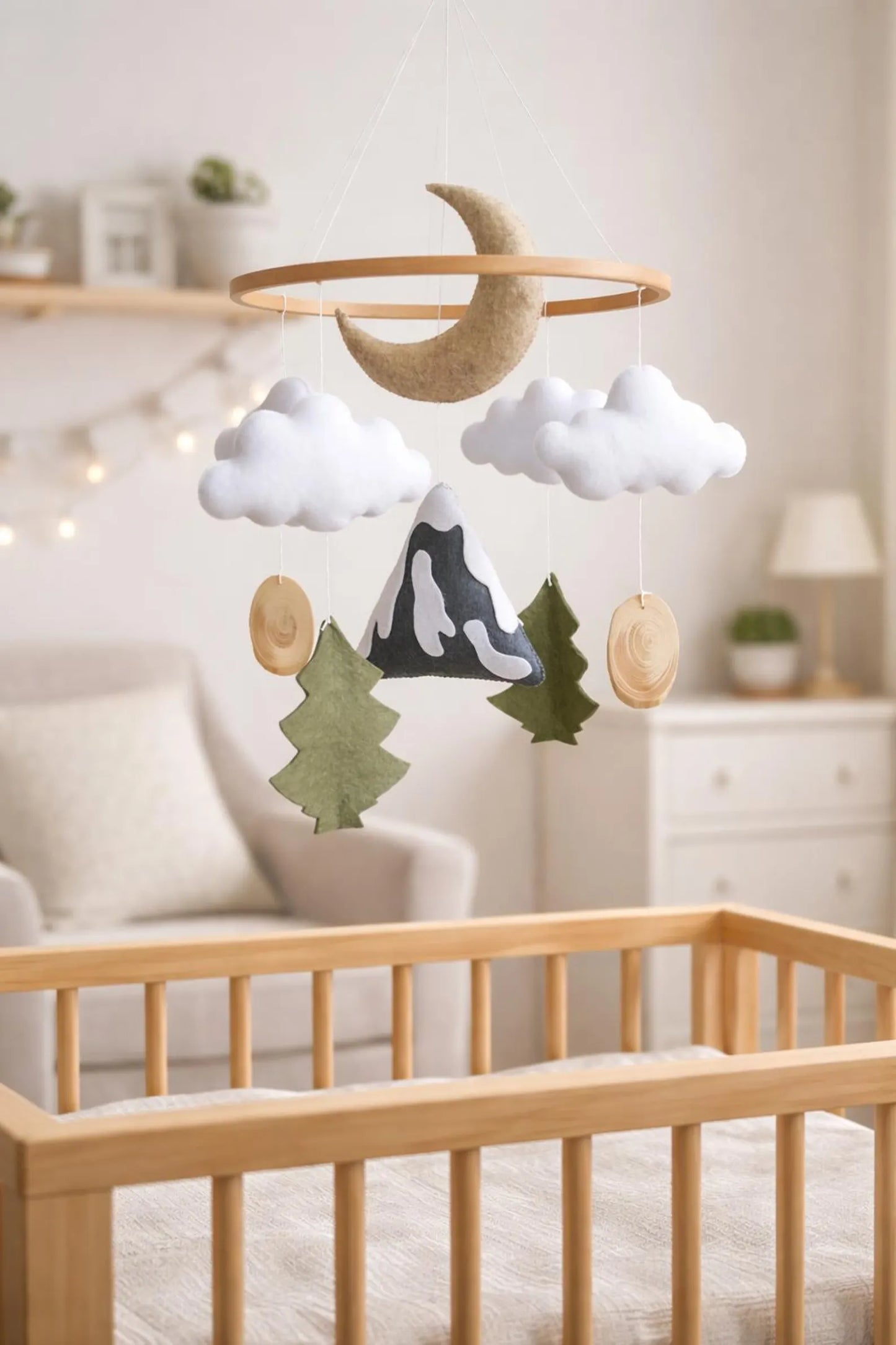Felt mountain moon mobile in nursery above crib – woodland nature baby room decor