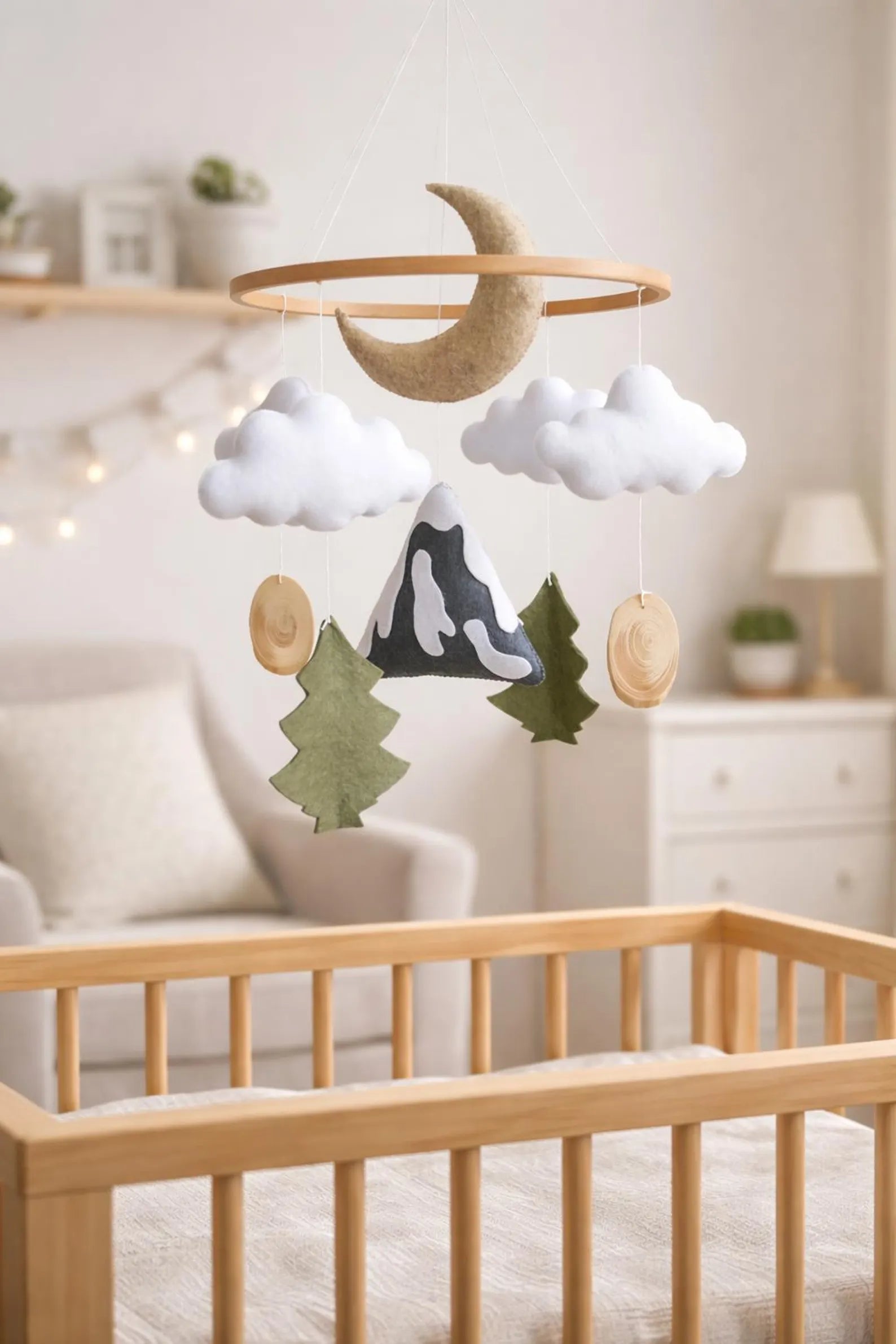 Felt mountain moon mobile in nursery above crib – woodland nature baby room decor