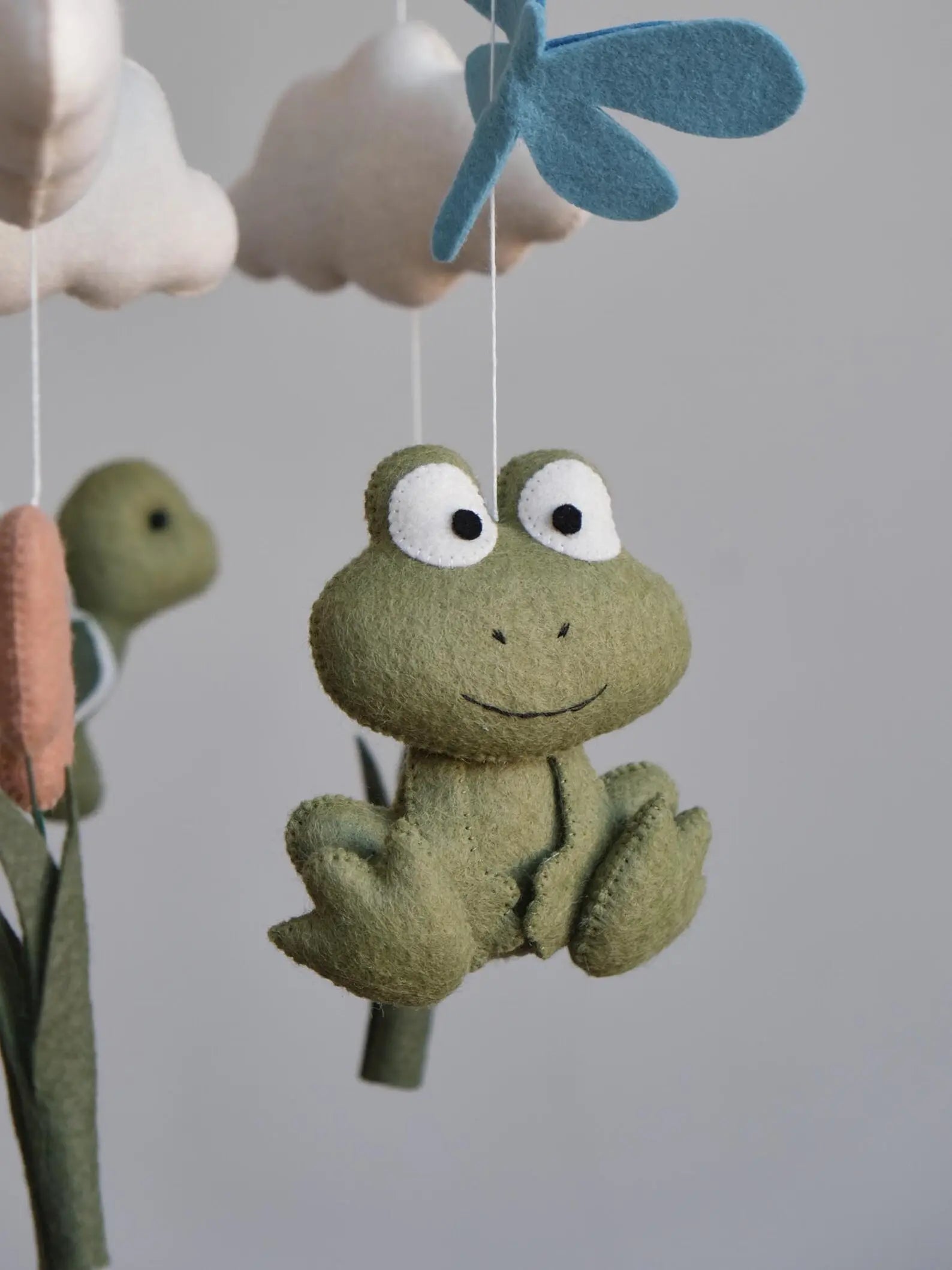 Felt frog baby mobile closeup – handmade pond nursery decor detail