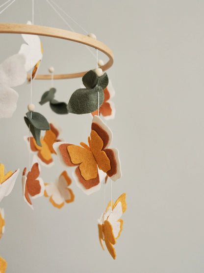 Felt neutral butterfly closeup – amber and terracotta layered wings on handmade baby mobile