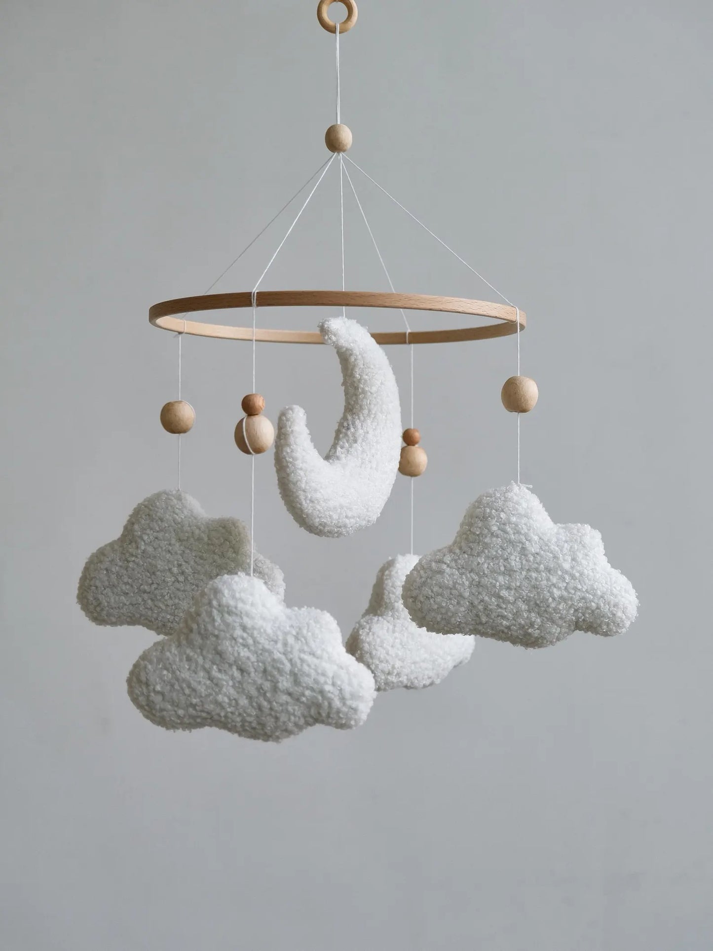 Handmade plush crib mobile with boucle moon and four white clouds with wooden beads