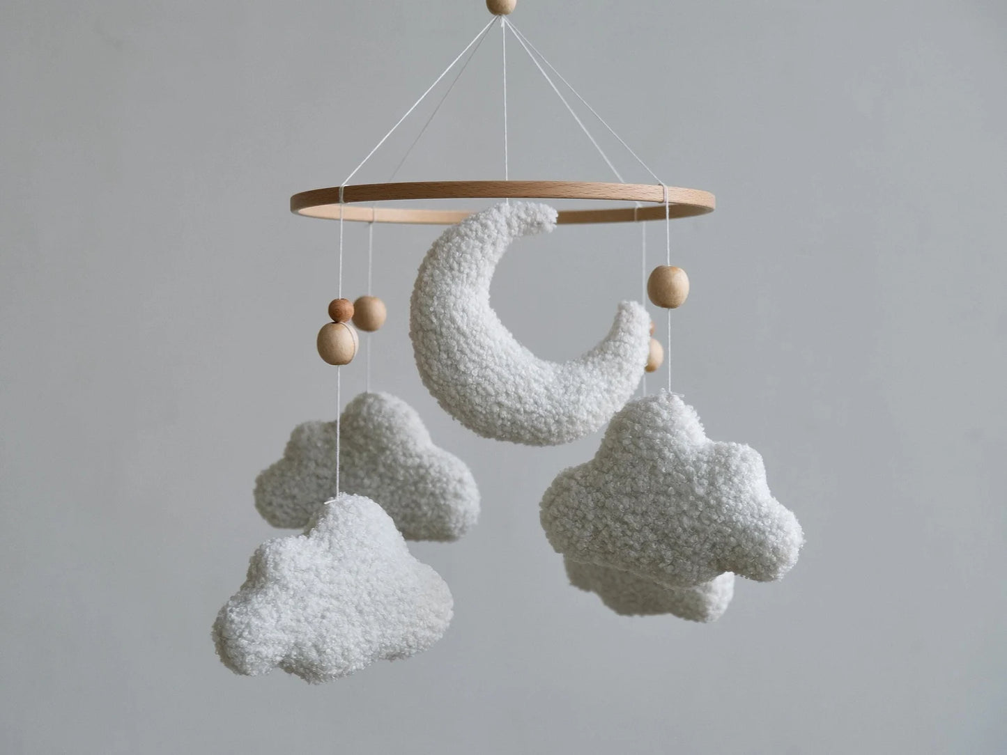 Plush boucle baby mobile with crescent moon and clouds on wooden ring front view