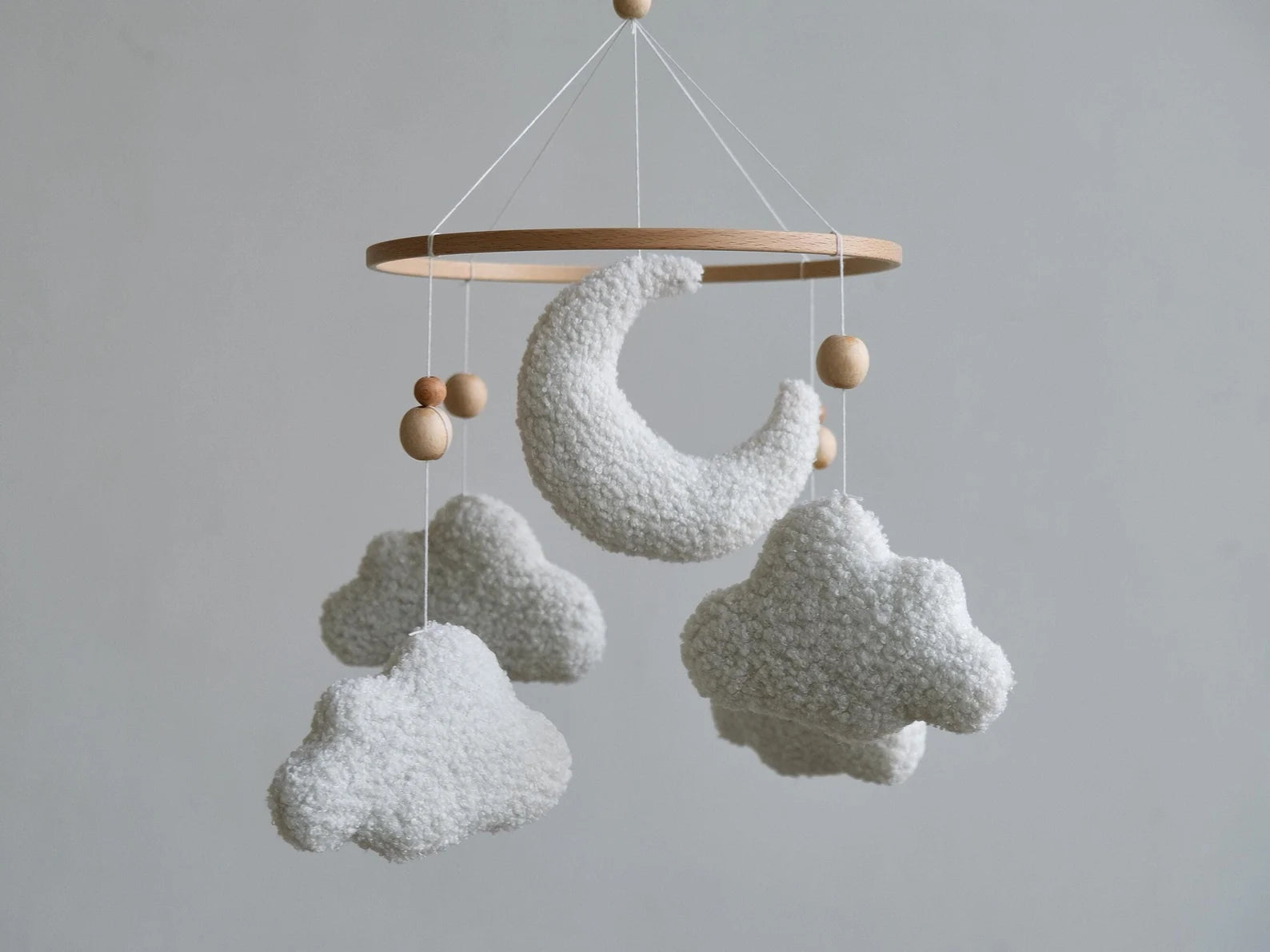 Plush boucle baby mobile with crescent moon and clouds on wooden ring front view
