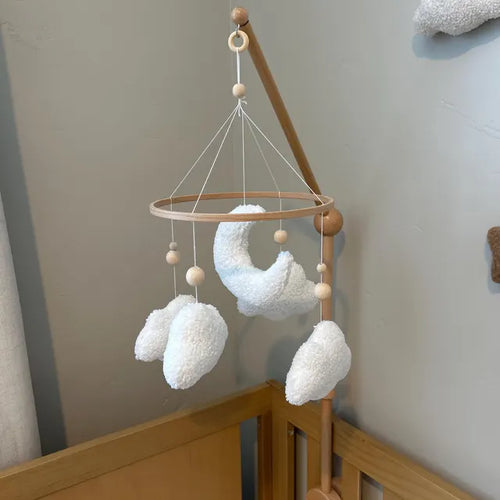 Customer review photo of a boucle sheep, cloud and moon baby mobile above a wooden crib