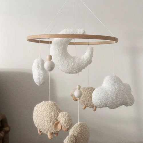 Customer photo of a soft boucle baby mobile with beige sheep, white clouds and a crescent moon