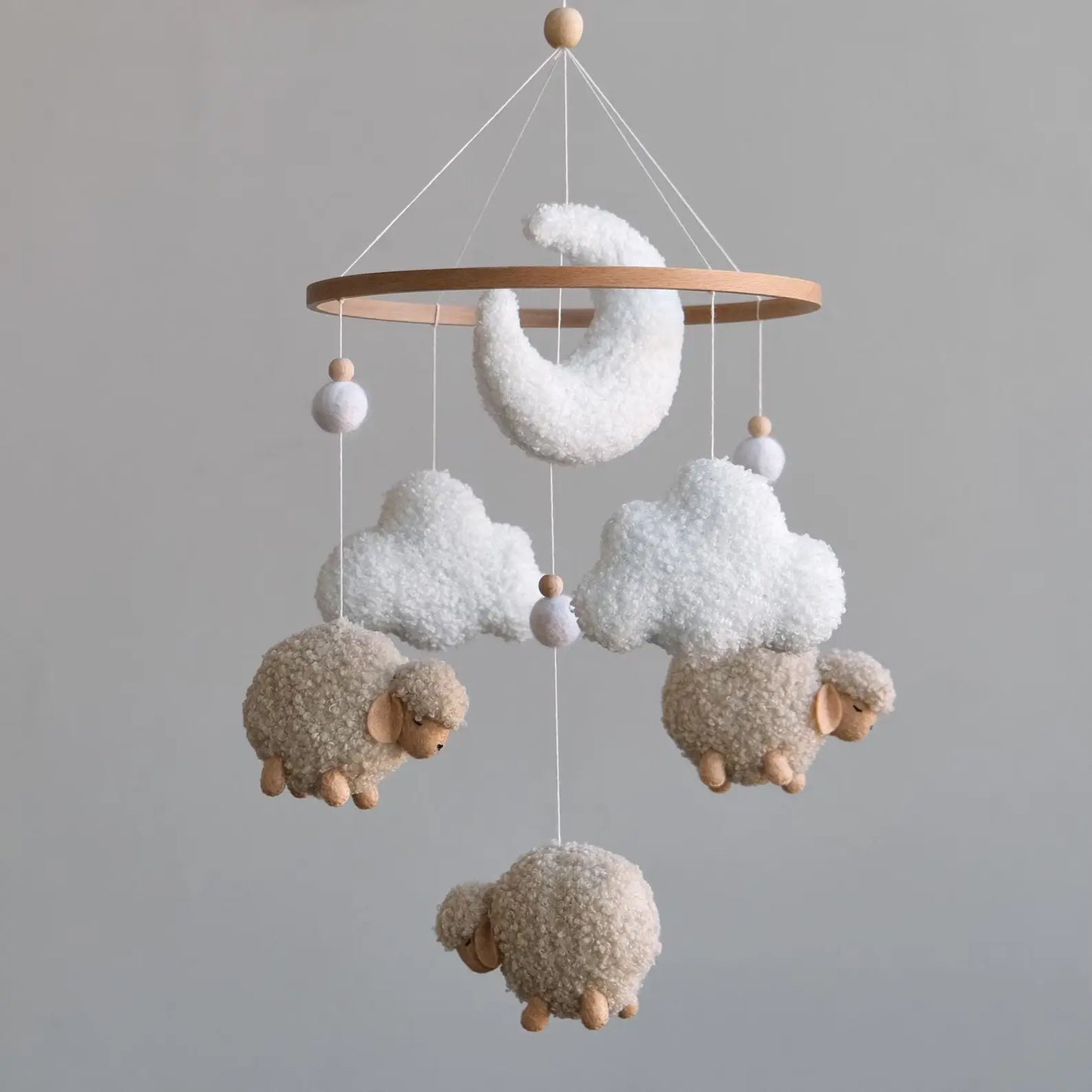Soft baby mobile with three beige boucle sheep two clouds and crescent moon