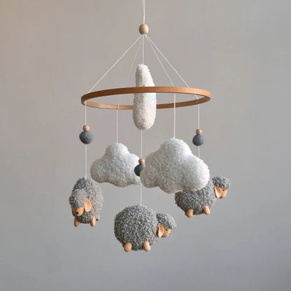 Grey boucle sheep crib mobile with white clouds and wooden beads on natural ring