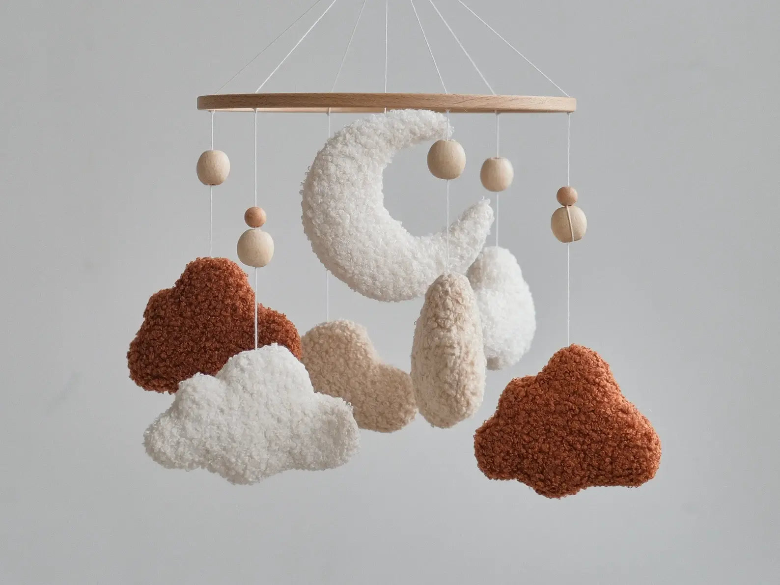 Handmade boucle cloud and moon crib mobile in terracotta and white with natural wooden beads