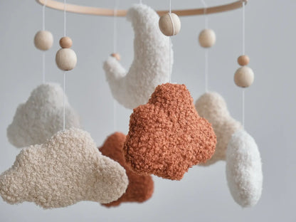 Close-up of boucle fabric texture on terracotta cream and beige cloud mobile