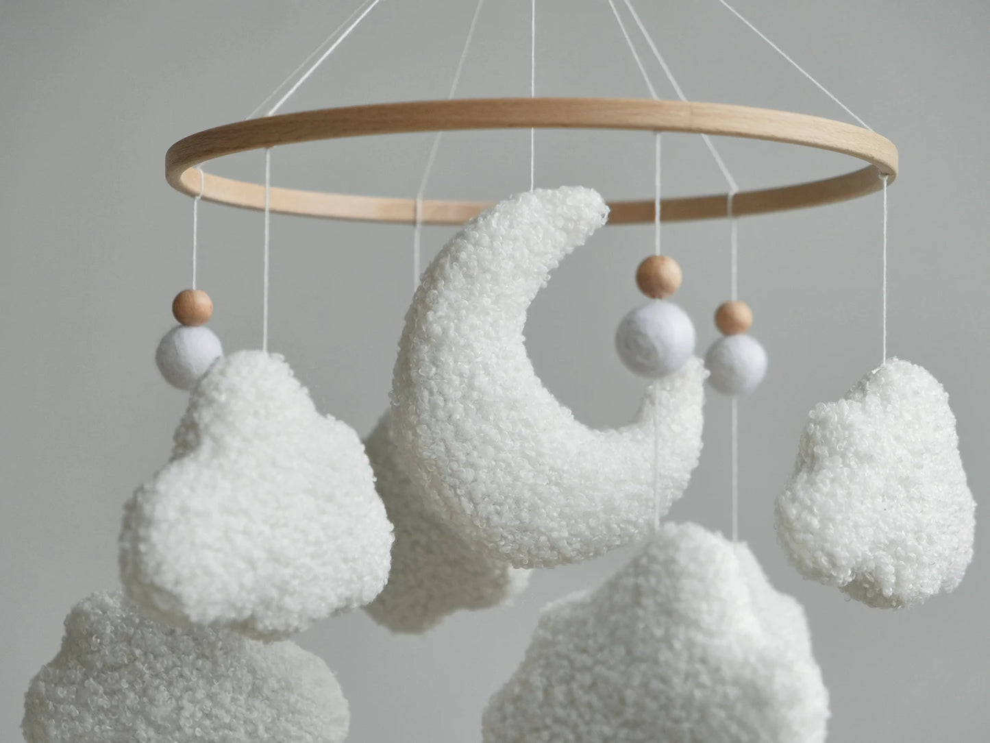 Boucle moon and clouds mobile close-up – soft textured plush crescent moon crib mobile detail